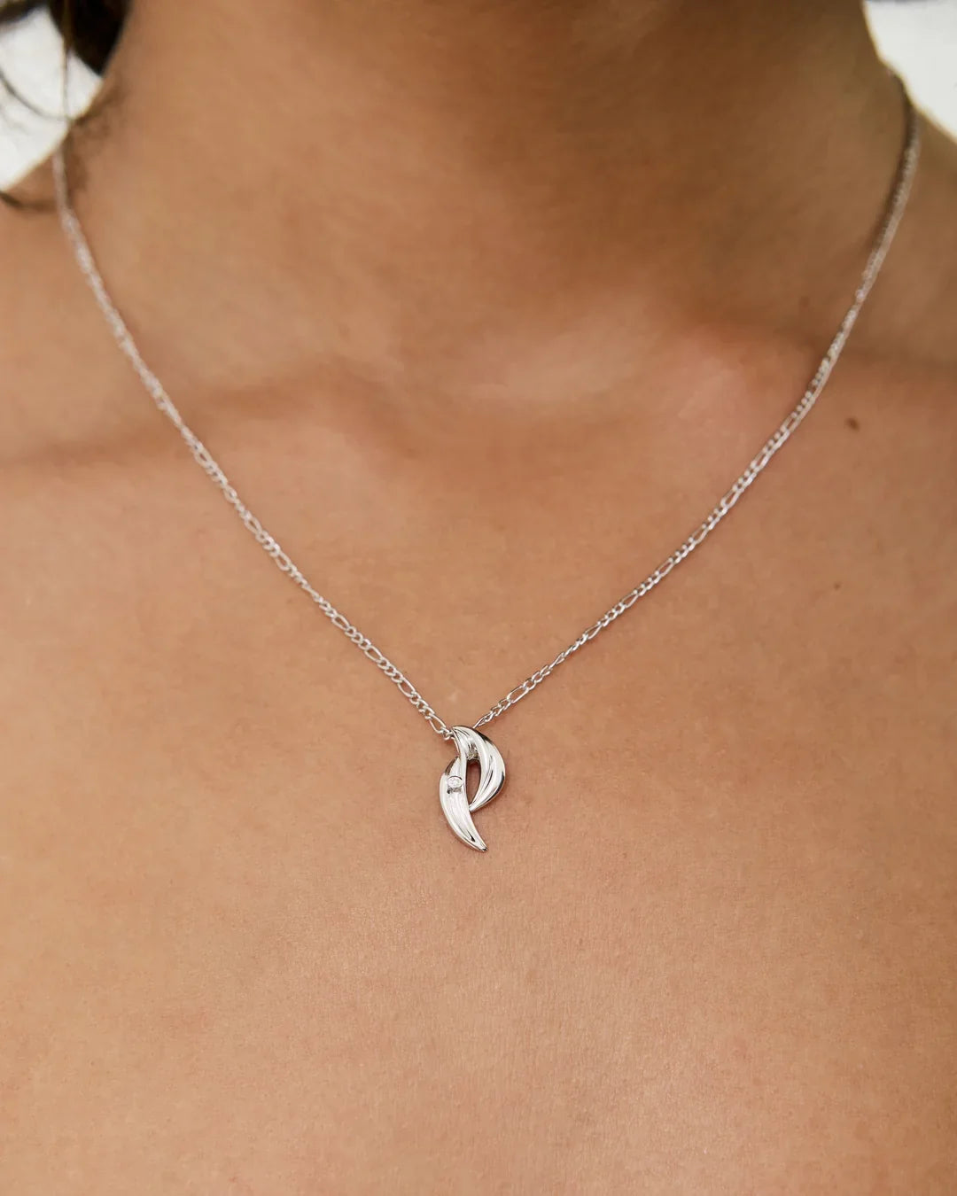 P पी Initial Necklace in polished silver-toned metal, with a fine chain and a curved P-shaped pendant.