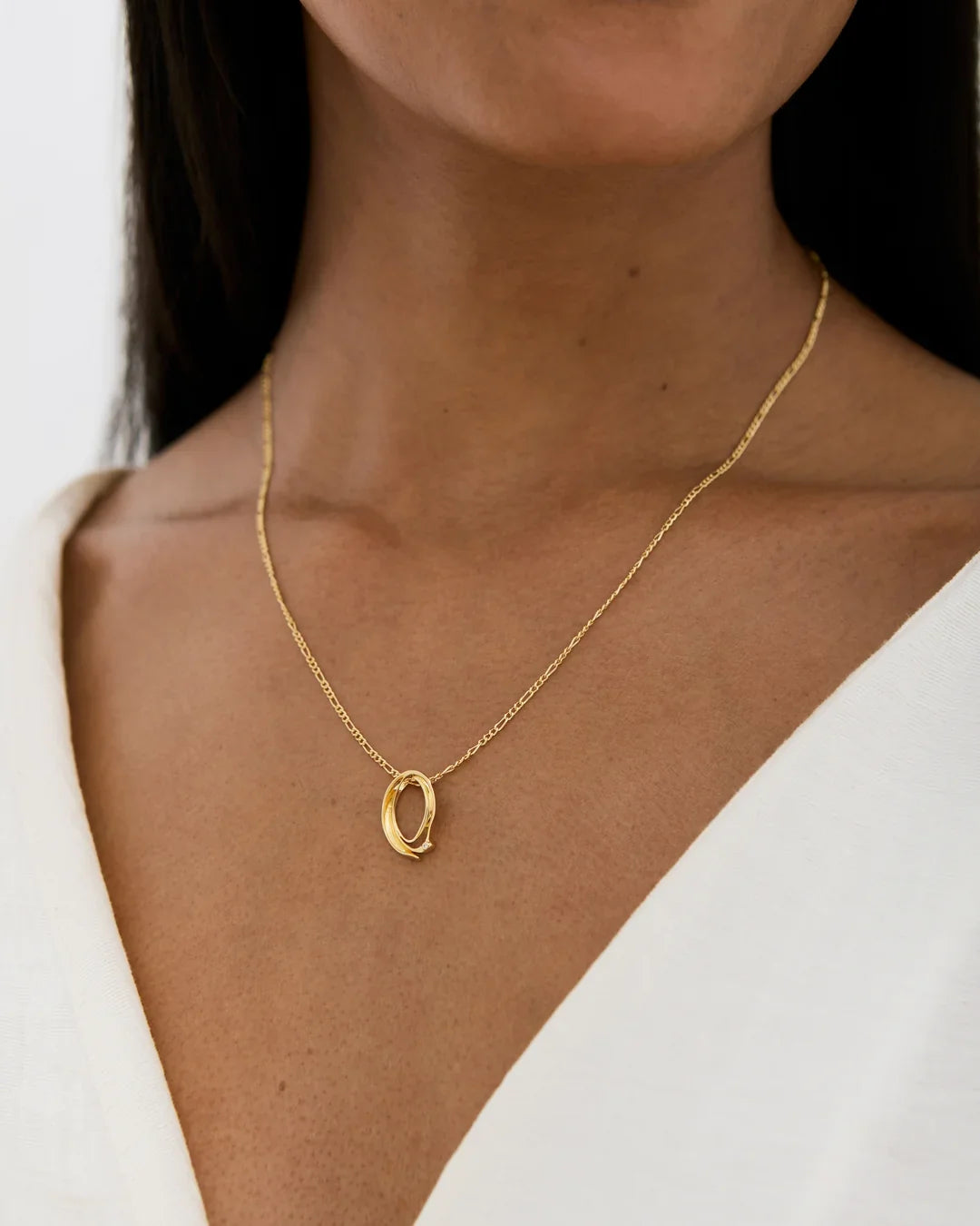 Q क्यू Initial Necklace, delicate gold-tone chain with a small polished oval pendant featuring an open center.