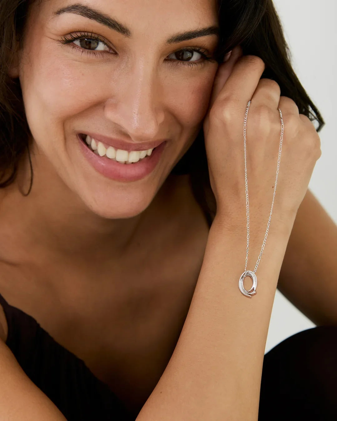 Q क्यू Initial Necklace in silver-tone metal, with a delicate chain and circular Q-shaped pendant.