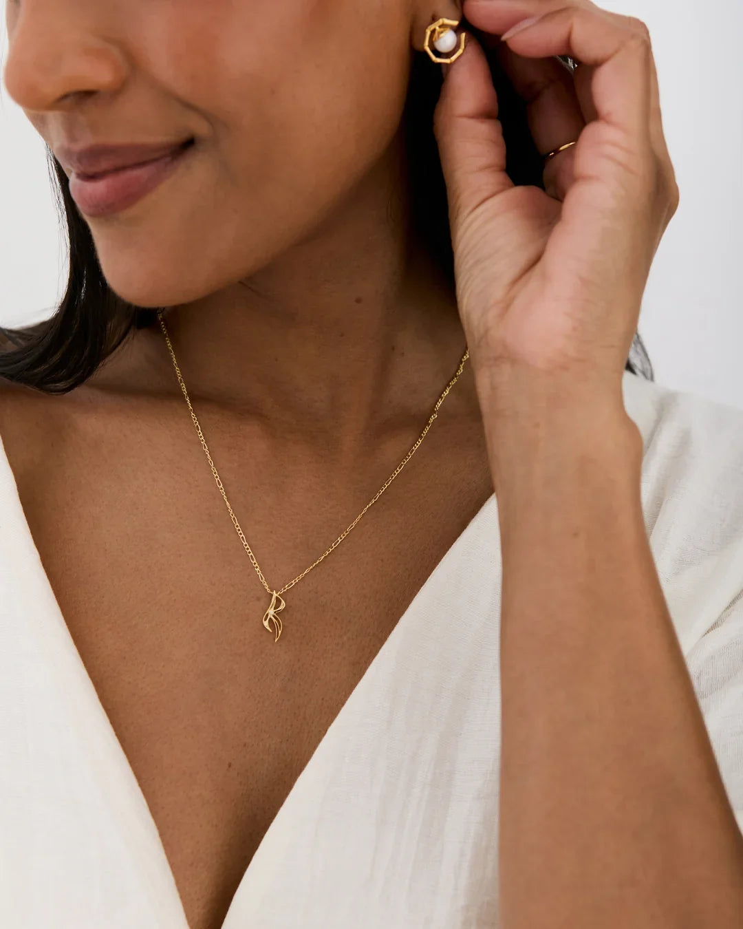 R आर Initial Necklace in gold-tone metal, with a fine chain and delicate R-shaped pendant, paired with a matching stud earring