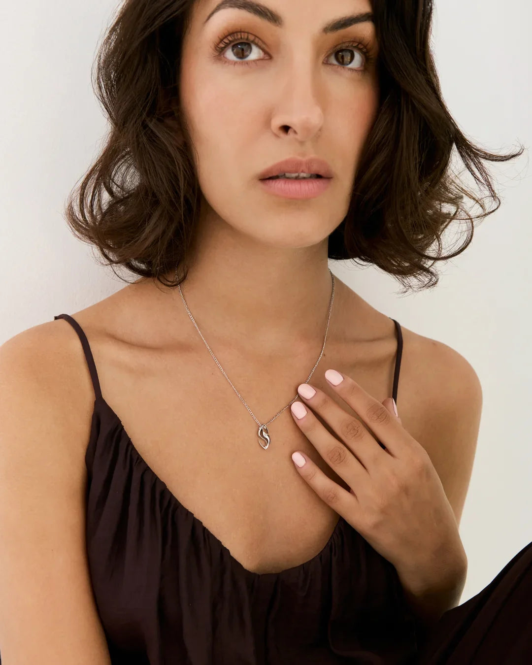 S एस Initial Necklace in silver-tone metal with a fine chain and a small, curved S-shaped pendant
