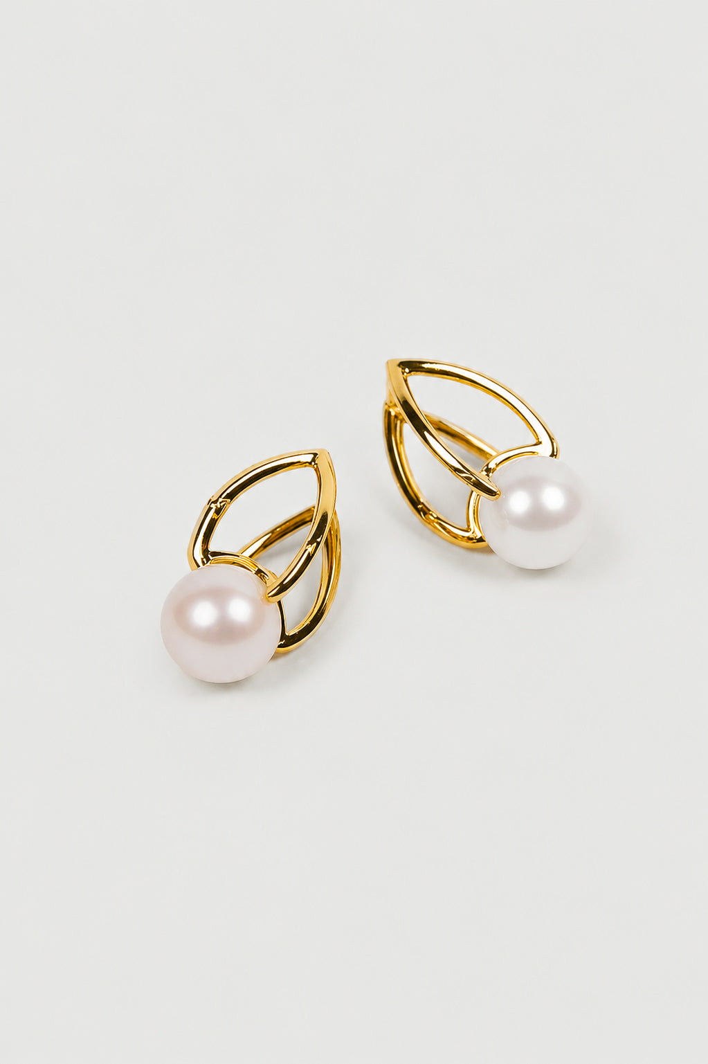 Shanta Earring with luminous pearl and open gold design showcasing modern, sculptural elegance