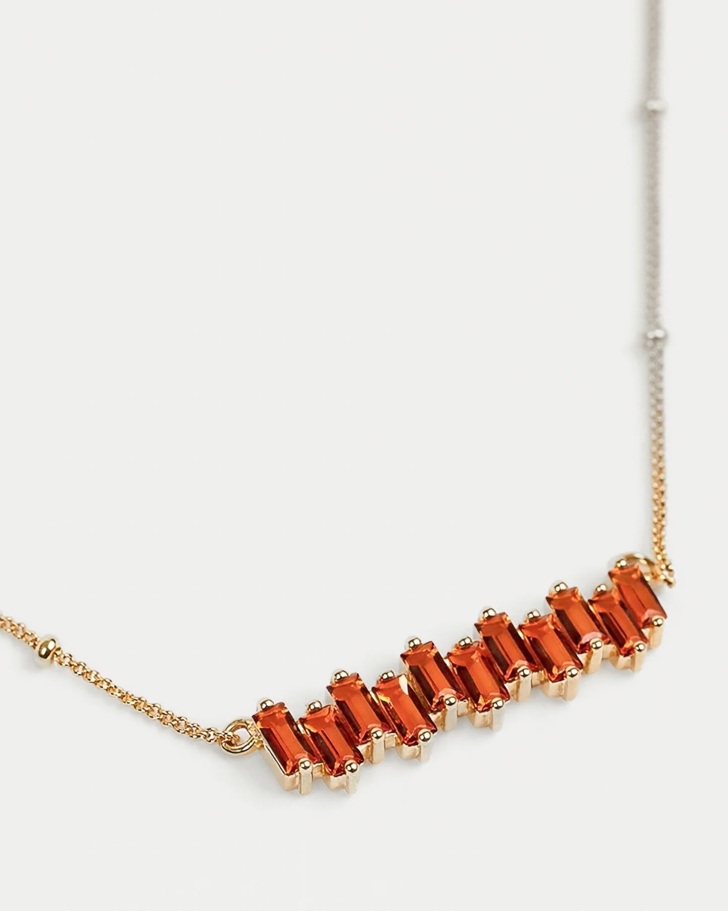 Minimal Sutra Necklace close to skin complementing bold rings with citrine stones