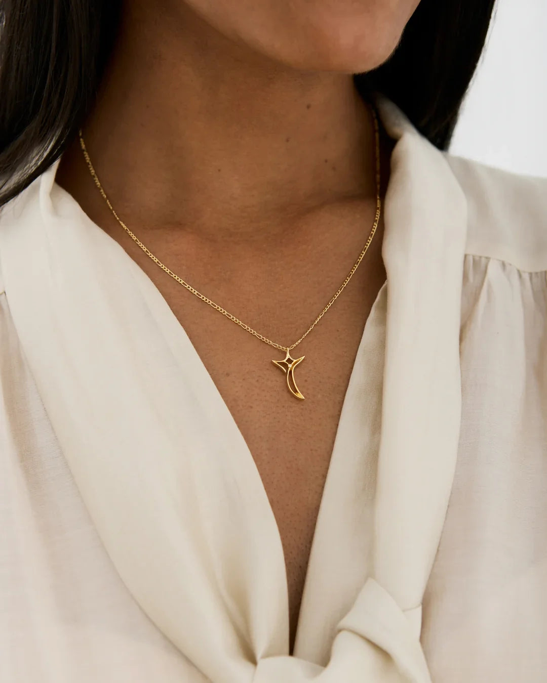 T टी Initial Necklace in gold-tone metal with a fine chain and a curved crescent-shaped pendant featuring a small star detail.