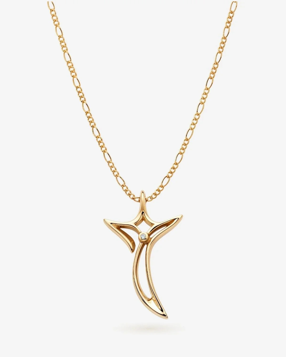 T टी Initial Necklace with a gold-tone chain and polished, abstract T-shaped pendant featuring a small clear stone.