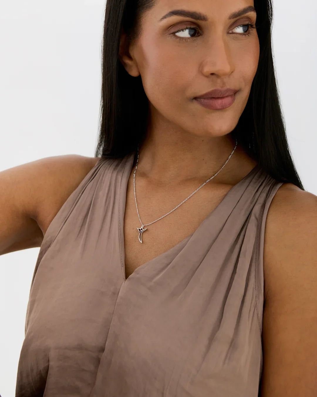 T टी Initial Necklace in silver-tone metal, with a delicate chain and small T-shaped initial pendant accented with a stone.