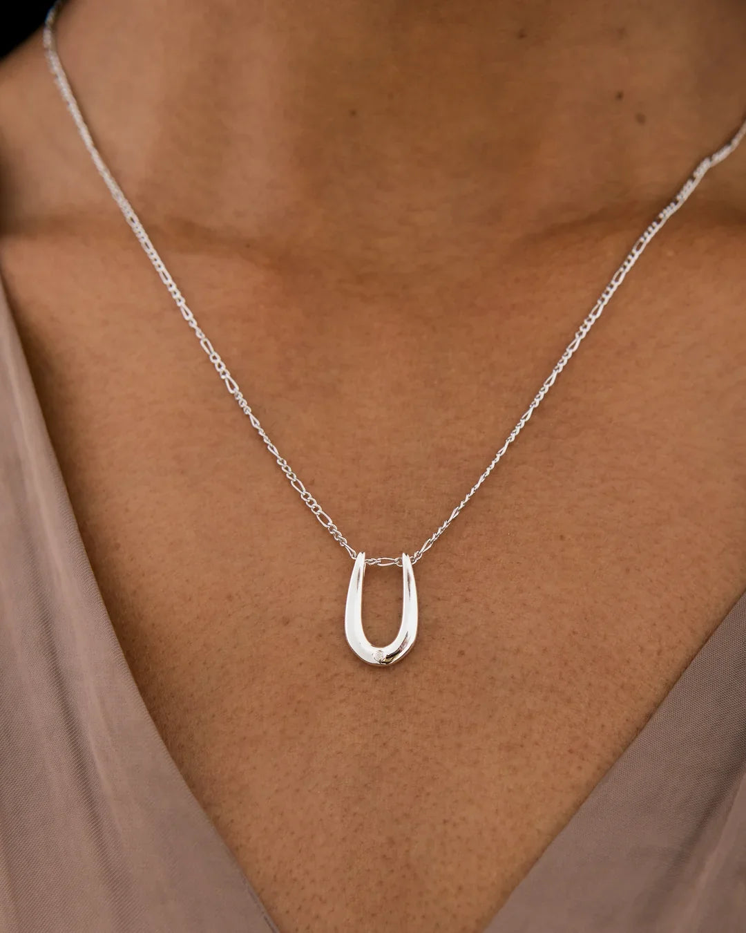U यू Initial Necklace in polished silver-colored metal, with a delicate chain and distinctive open U-shaped pendant.