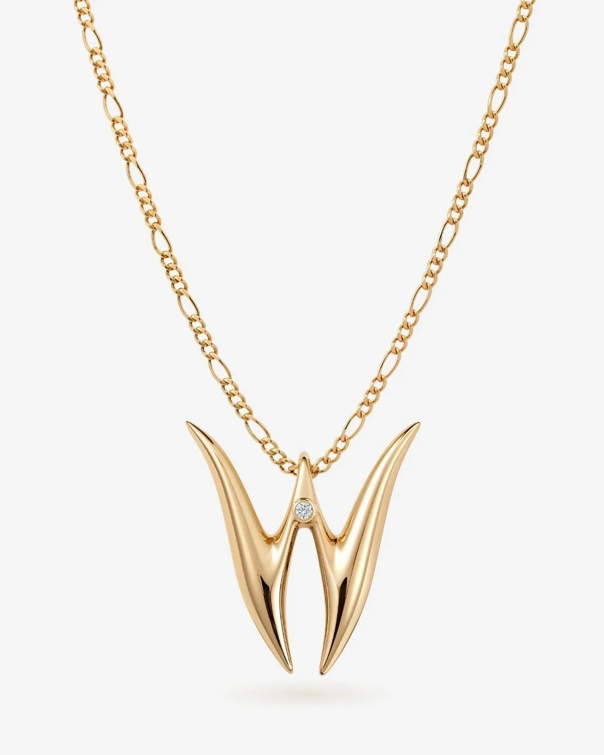 W डब्ल्यू Initial Necklace in gold-tone metal, featuring a sculpted double-pointed W pendant with a small clear stone.