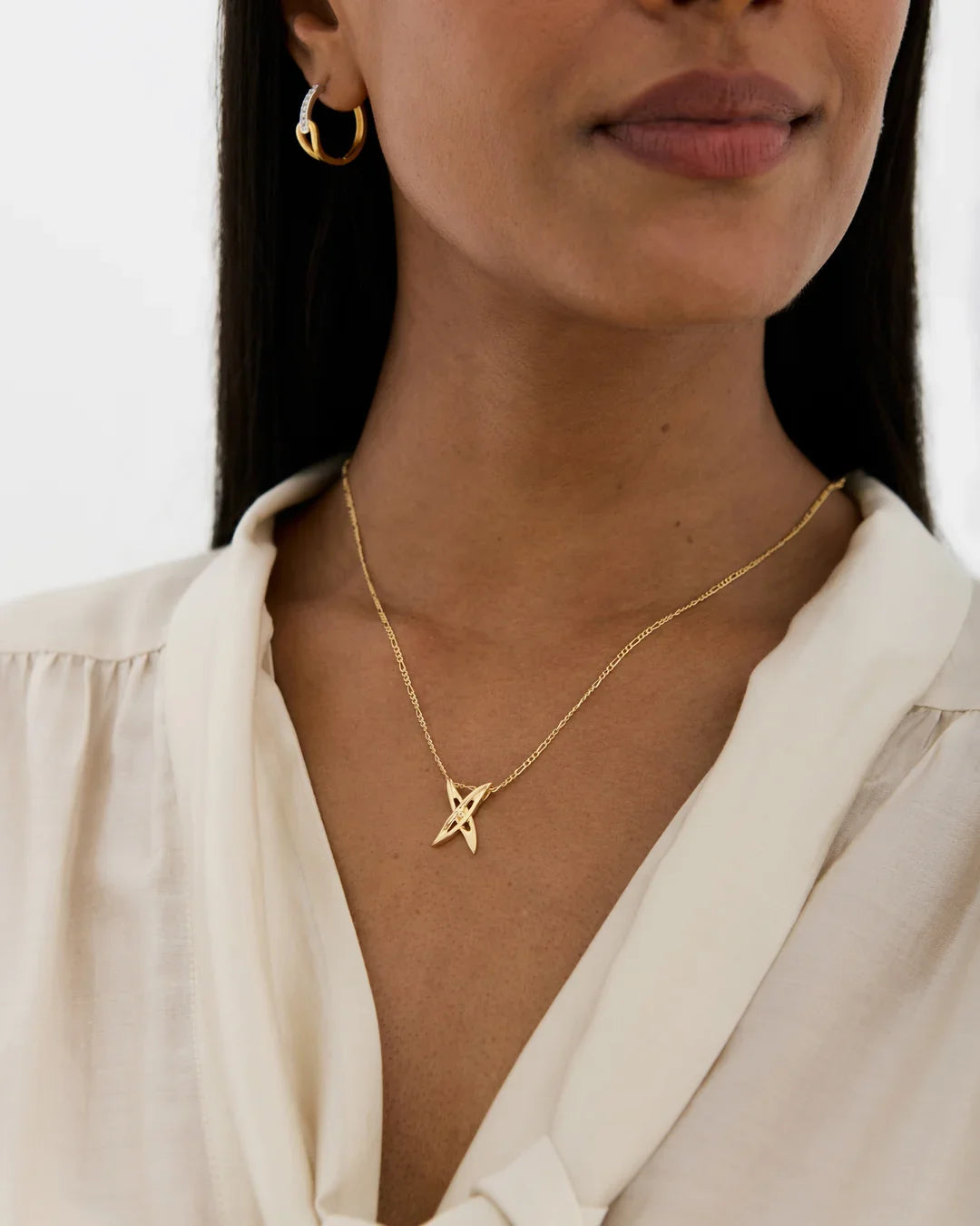 X एक्स Initial Necklace in gold-tone metal with a fine chain and small crossed-line X pendant.