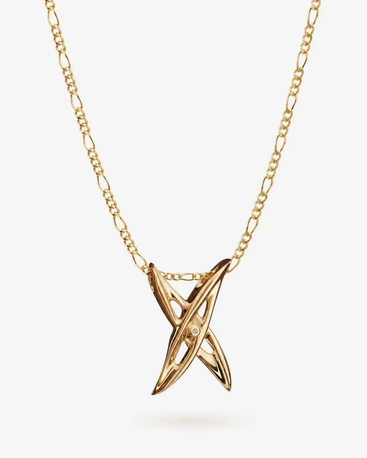 X एक्स Initial Necklace in polished gold-tone metal, featuring a sculptural crossed X pendant with a small clear stone.