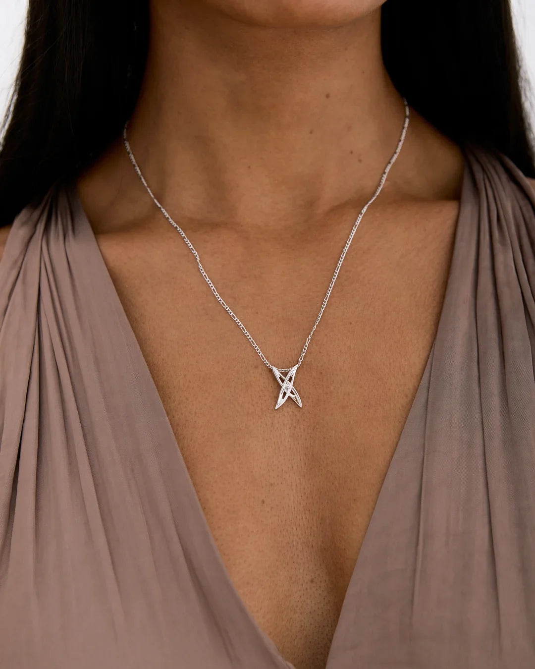 X एक्स Initial Necklace in silver-tone metal, with a delicate chain and a small crossed X-shaped pendant accented by clear stones.