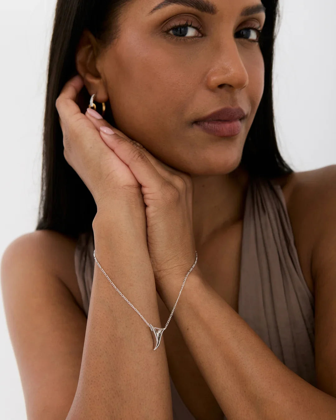 Y वाई Initial Necklace in silver-tone metal with a fine chain and a small, angular Y-shaped pendant.