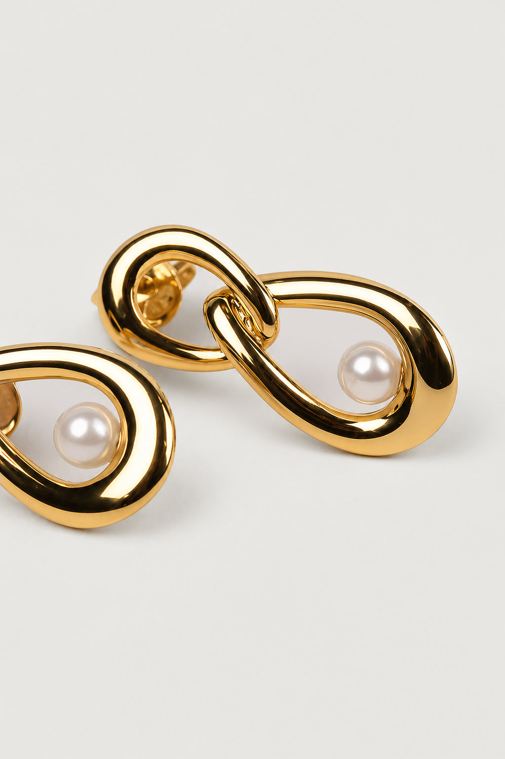 Yukti Earring featuring two vertically aligned open oval forms connected with a modern, balanced design
