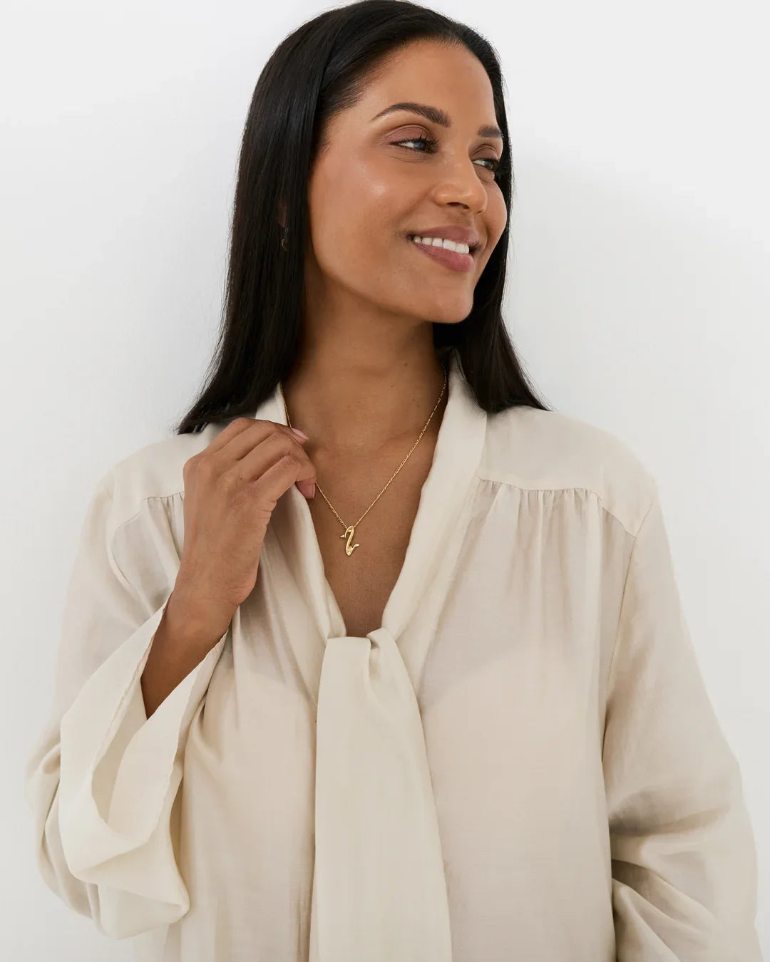 Z ज़ेड Initial Necklace, a delicate gold-tone chain with a small Z-shaped pendant worn at the neckline.