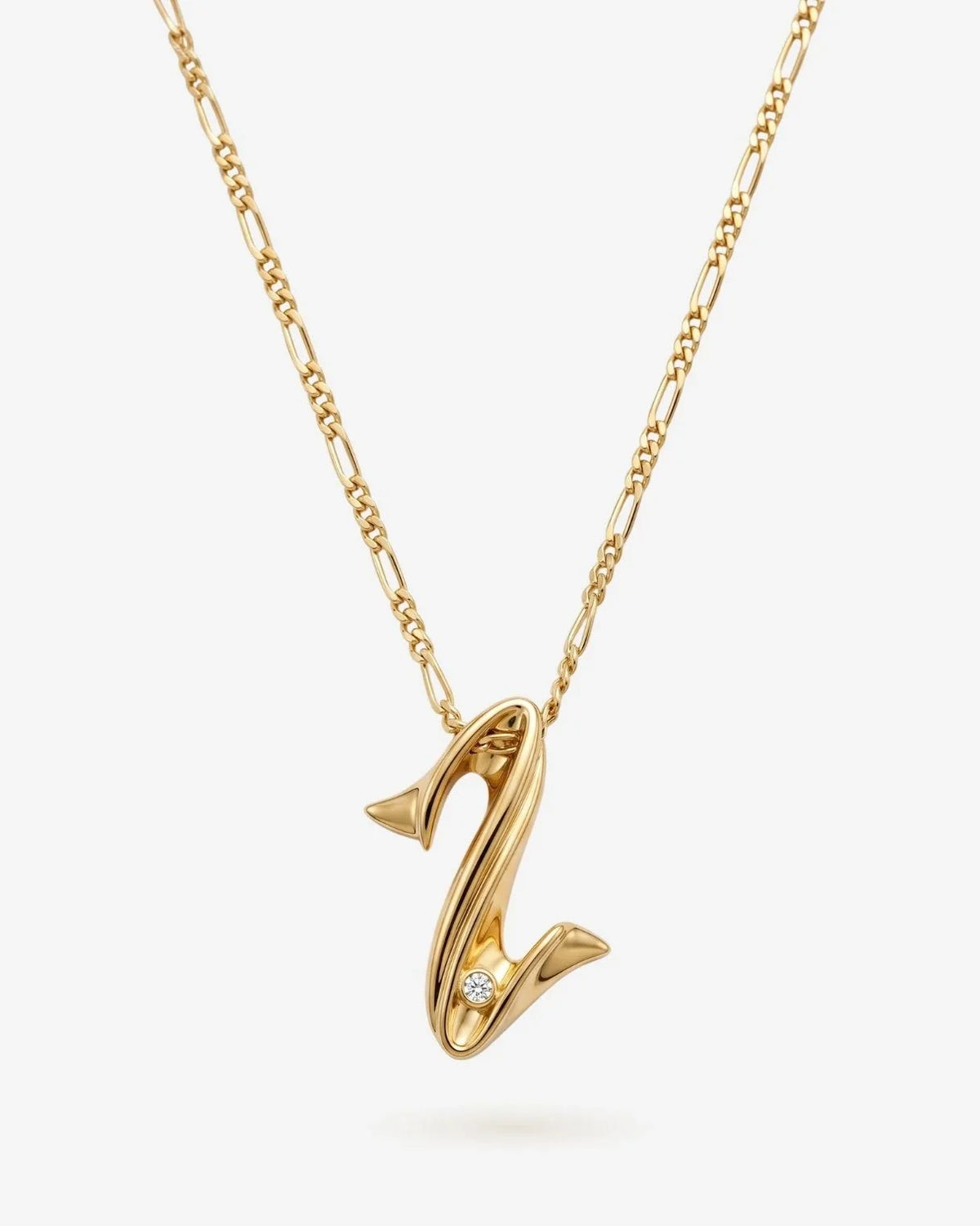 Z ज़ेड Initial Necklace in polished gold-tone metal, with a sculpted Z pendant and a small clear accent stone.