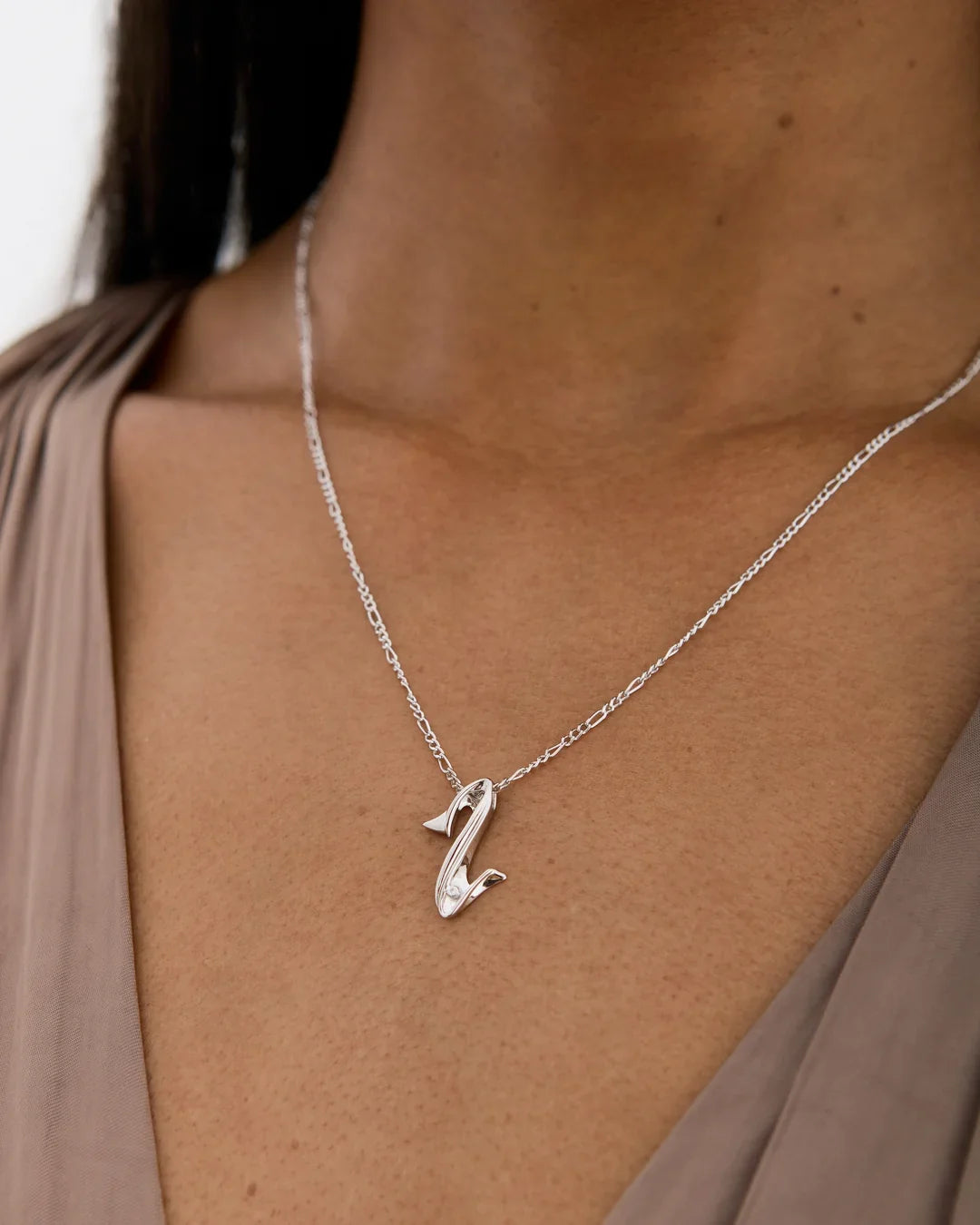 Z ज़ेड Initial Necklace in polished silver-tone metal, with a fine chain and a sculpted, curved letter Z pendant.